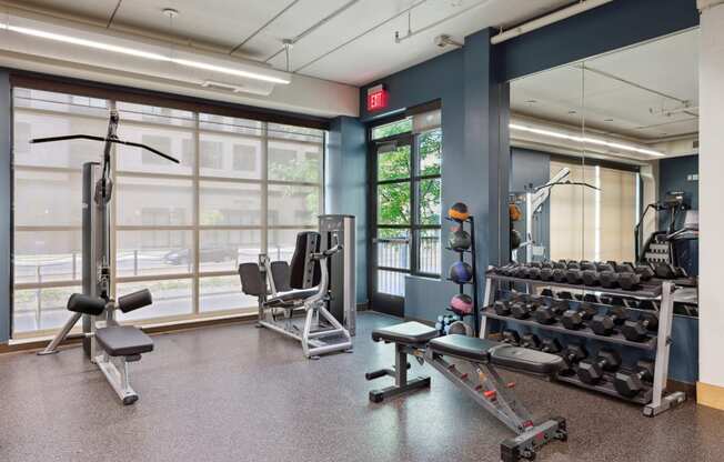 a workout room with weights and other exercise equipment