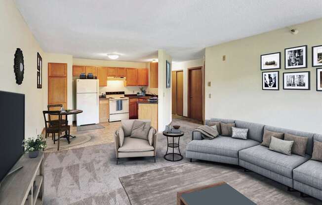 A living room with a grey couch, a wooden table and a potted plant.