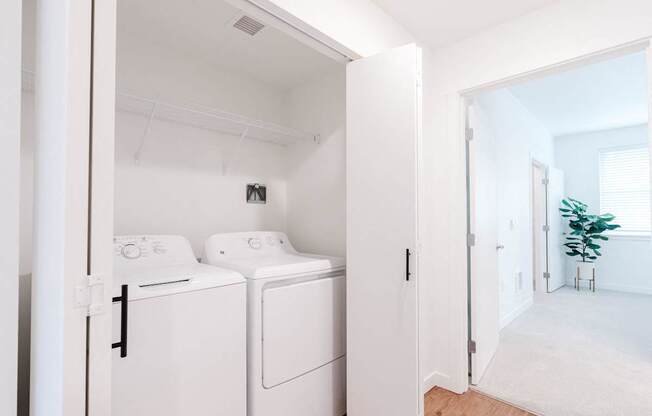 A white laundry room with a washer and dryer.