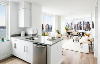 Windowed kitchen and corner living area with Manhattan skyline views. Apartment 2108.