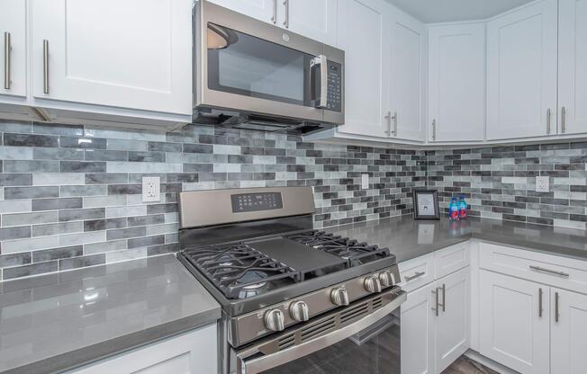 a stove top oven sitting inside of a kitchen