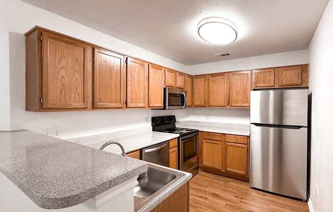 A kitchen with wooden cabinets and stainless steel appliances.