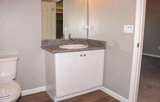 a kitchen with a sink and a mirror