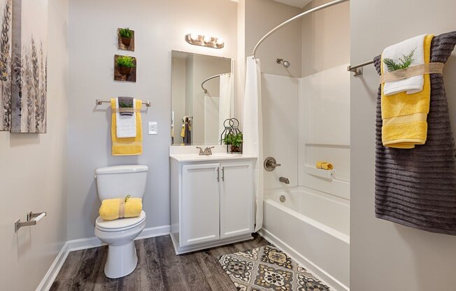 Spacious bathroom with vinyl flooring, white storage cabinets and soaking tub at The Summit on 401.