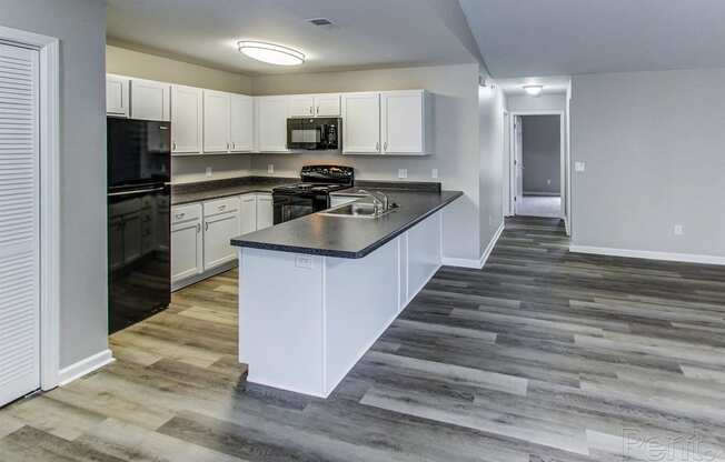 a kitchen with white cabinets and a counter top