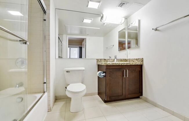 a bathroom with a toilet and a sink and a shower