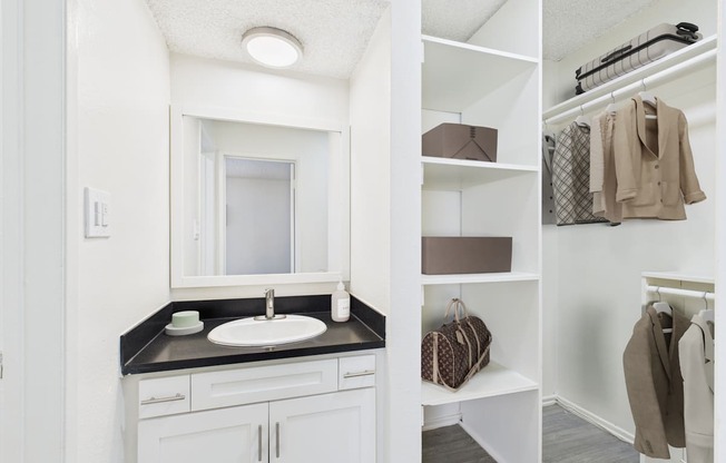 A bedroom with a large bed and a mirrored wardrobe.