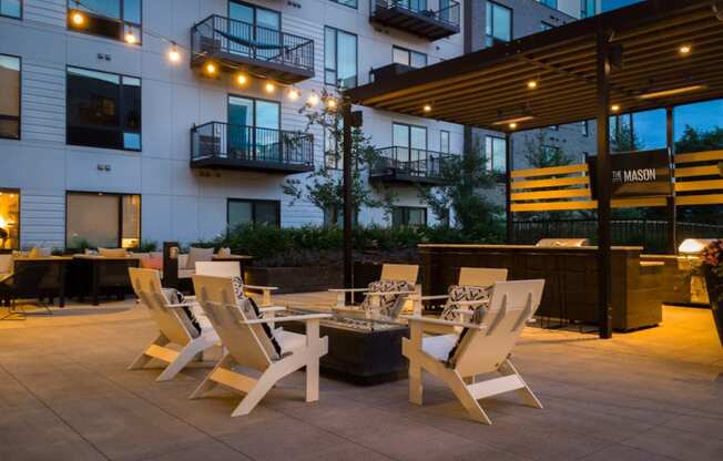 a patio with tables and chairs outside of a building