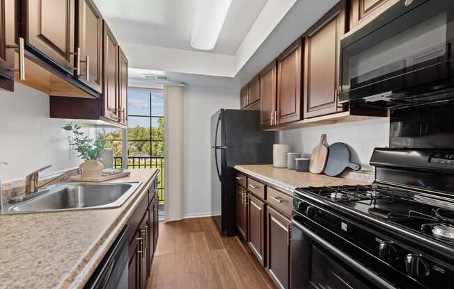 a kitchen with granite counter tops and black appliances