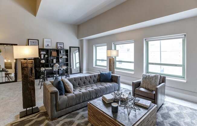 a living room with a couch and chairs and a table