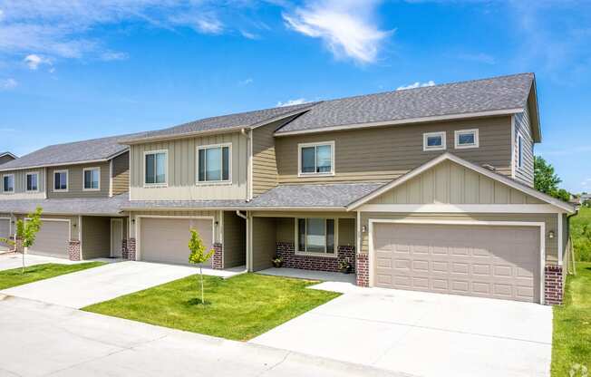 Well-maintained landscaping with manicured shrubs and paved walkways.