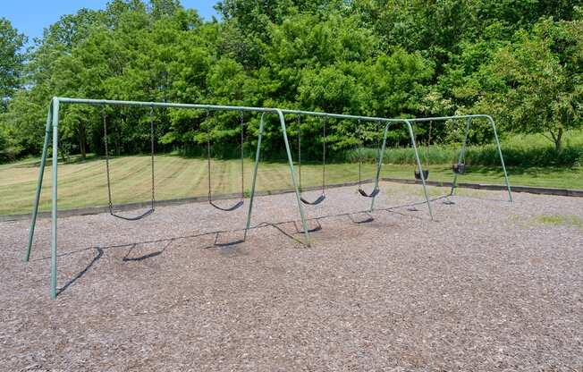 an empty swing set in a park