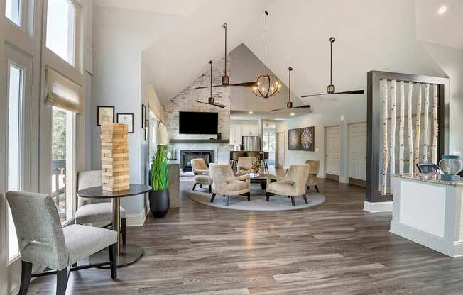 a living room with a table and chairs and a fireplace