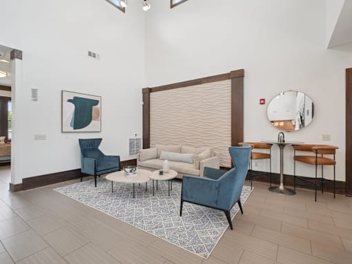 Modern resident lounge and clubhouse seating area at Village at Broadstone Station apartments in Apex, NC