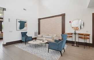 Modern resident lounge and clubhouse seating area at Village at Broadstone Station apartments in Apex, NC