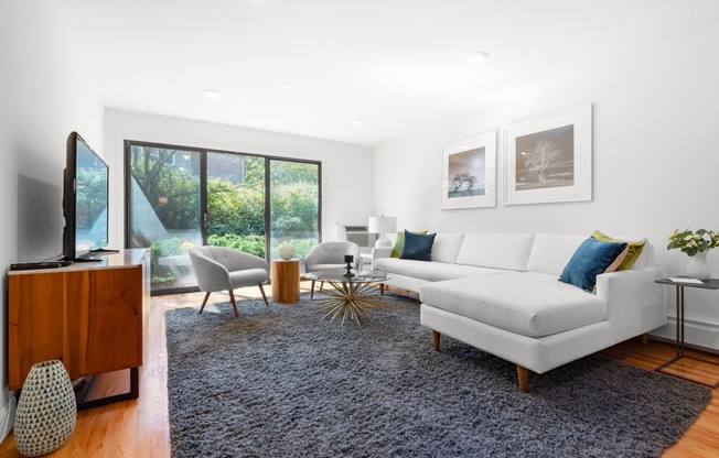 a living room with a white couch and a rug