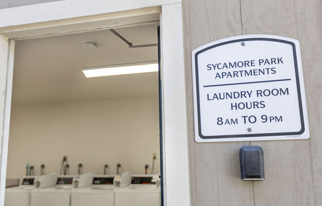 a sign for the sagamore park apartments laundry room hours