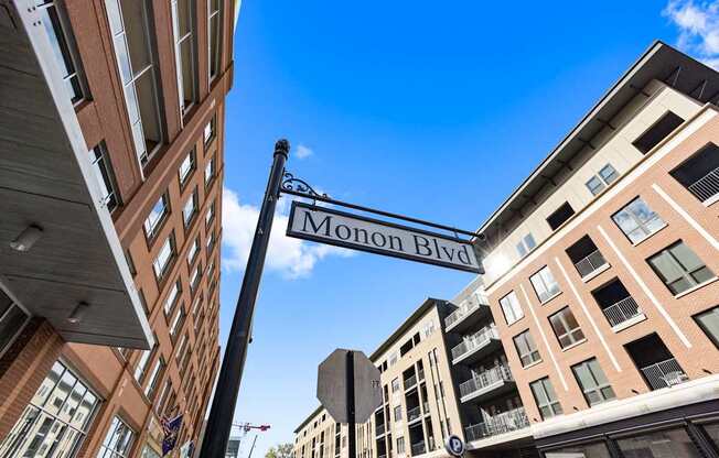 a street sign for monon blvd between two buildings