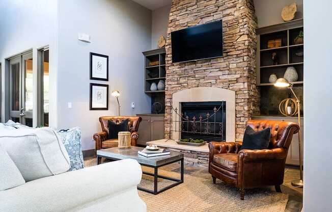 A living room with a fireplace and a flat screen TV mounted above it.