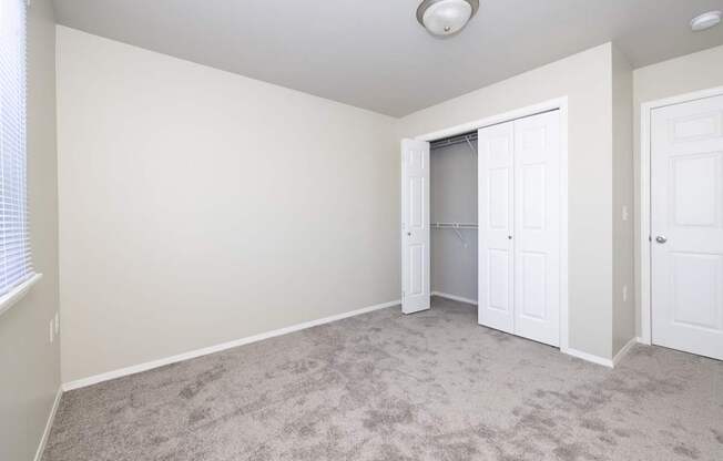 A room with a carpeted floor and white walls.