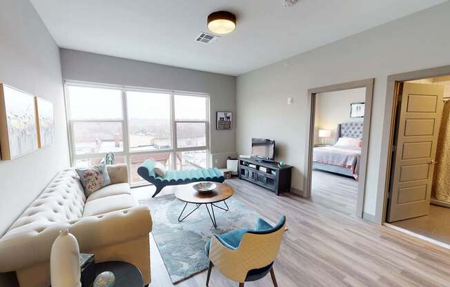 A living room with a white sofa and a blue chair.