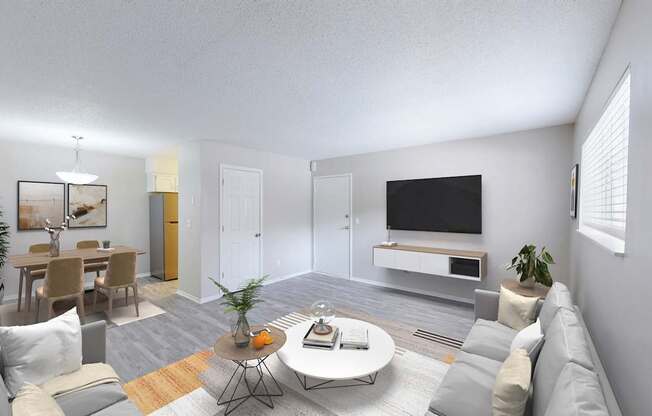 A modern living room with a grey sofa, a coffee table, and a television.