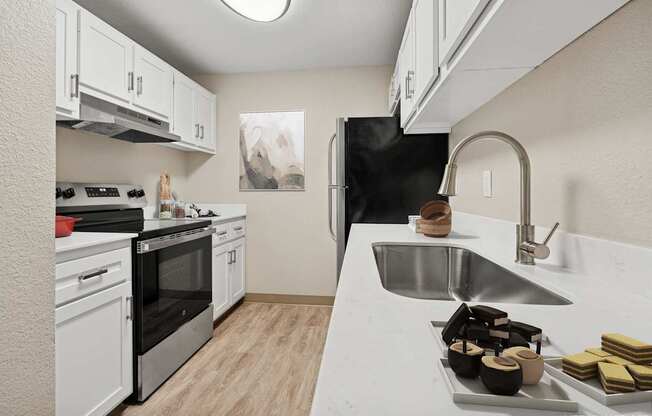 A kitchen with a black refrigerator, stove, and oven.