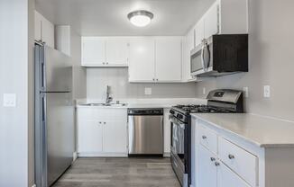 Kitchen with fridge and stovetop