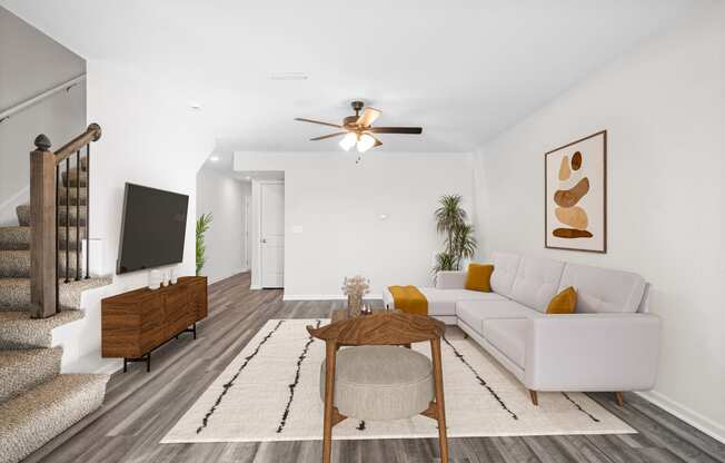 a living room with a white couch and a coffee table