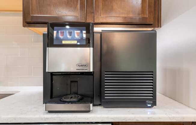 a coffee maker and a refrigerator on a kitchen counter