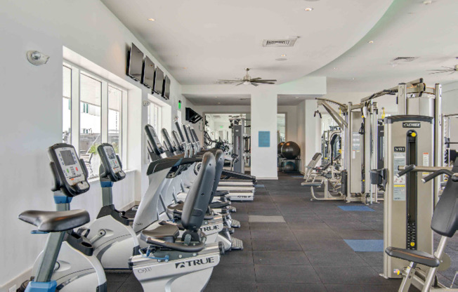 Exercise machines lined up in a Miami Florida apartment gym.
