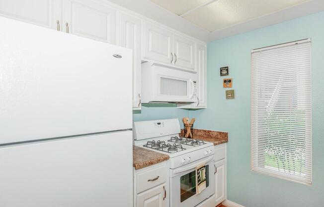 a white refrigerator freezer sitting inside of a kitchen