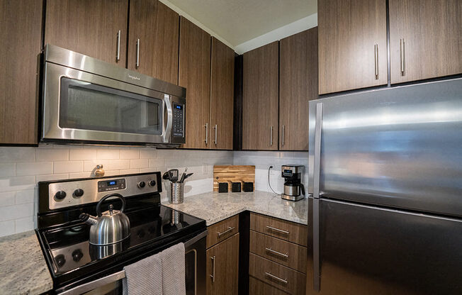 a kitchen with stainless steel appliances and granite counter tops