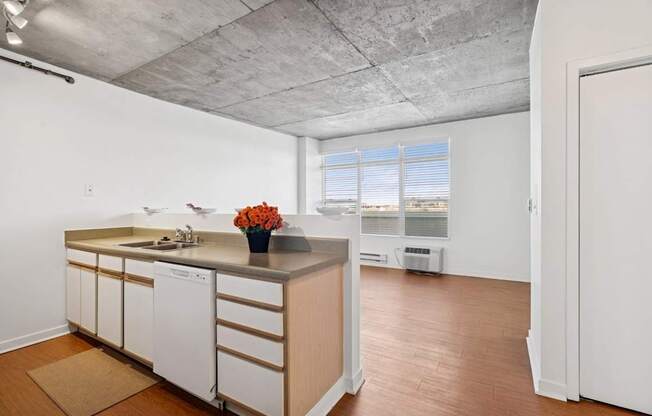 A kitchen with white cabinets and a wooden island.