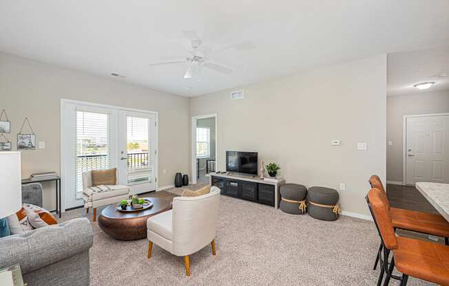 a living room with furniture and a ceiling fan