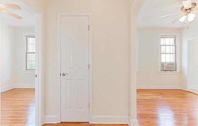 hallway with view of living area and bedroom with ceiling fan and hardwood flooring at parkside apartments in washington dc