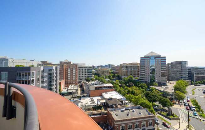 a view of the city from the balcony of a building on a sunny day