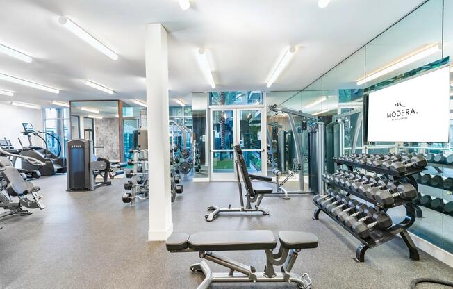 Modera Pomona offers a fitness center with cardio equipment, TRX system, and an interactive fitness mirror.