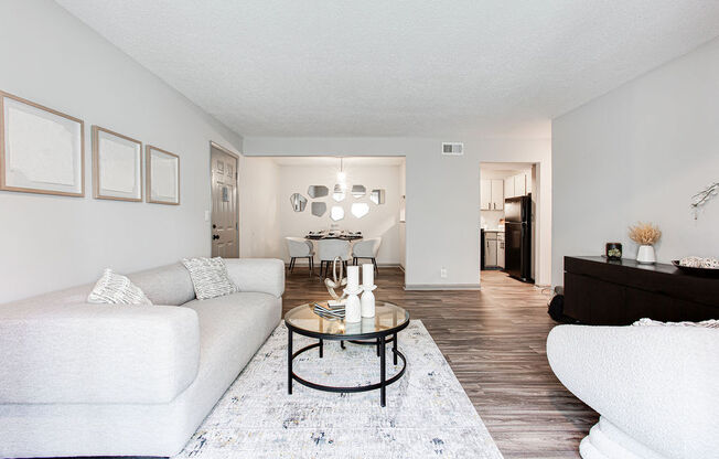 a living room with white couches and a glass coffee table at Hidden Lake, Union City, GA