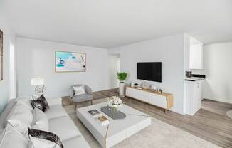 a living room with a white couch and a coffee table