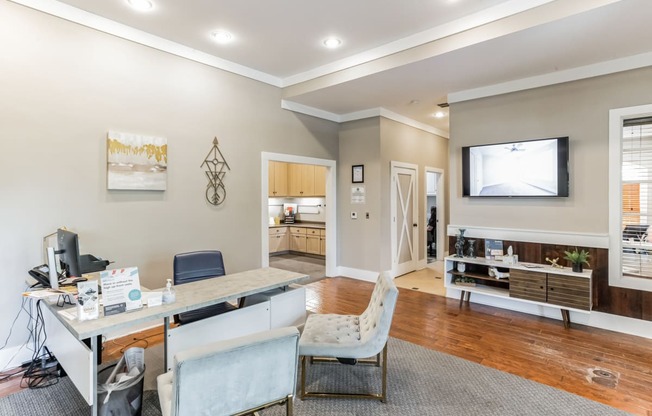 a home office with a desk and a tv