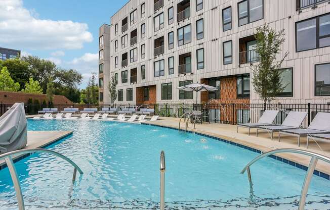 A large swimming pool in front of a modern building.