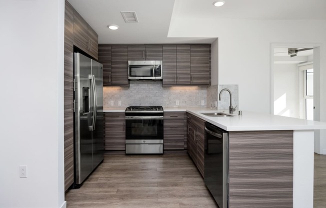 a kitchen with stainless steel appliances and a white counter top