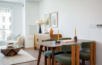 a dining room and living room with a table and chairs at Slabtown Square Apartments, Portland , OR 97209