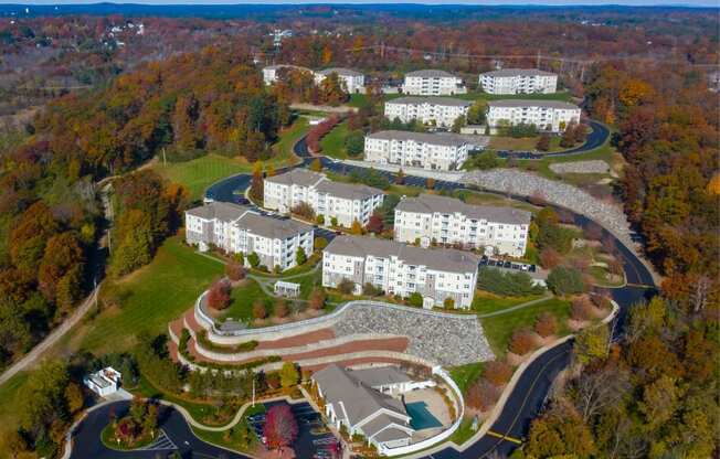 an aerial view of a campus with buildings and a winding road