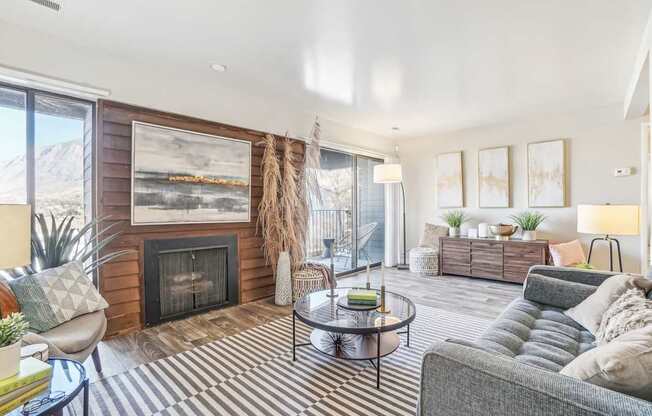 A living room with a fireplace and a painting on the wall.