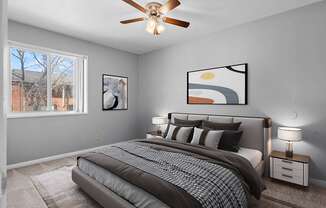 a bedroom with a large bed and a ceiling fan