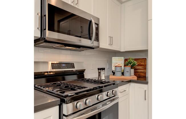 a stove top oven sitting inside of a kitchen