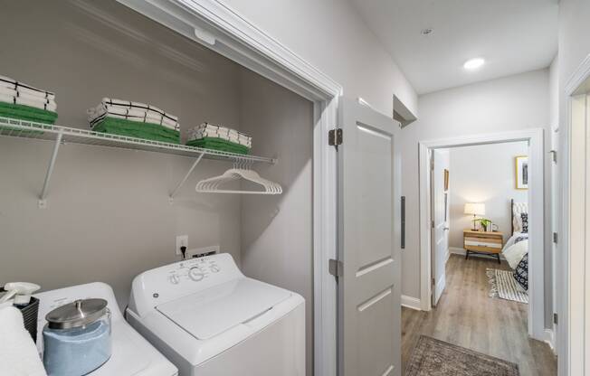 a white room with two beds and a sink in it