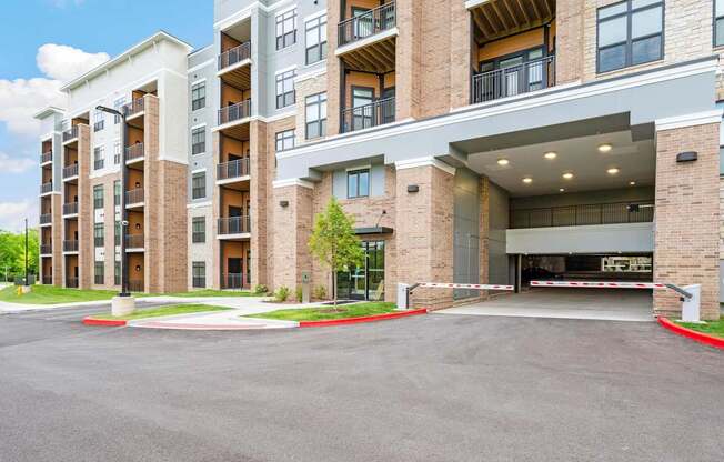 A large apartment complex with a parking lot in front.